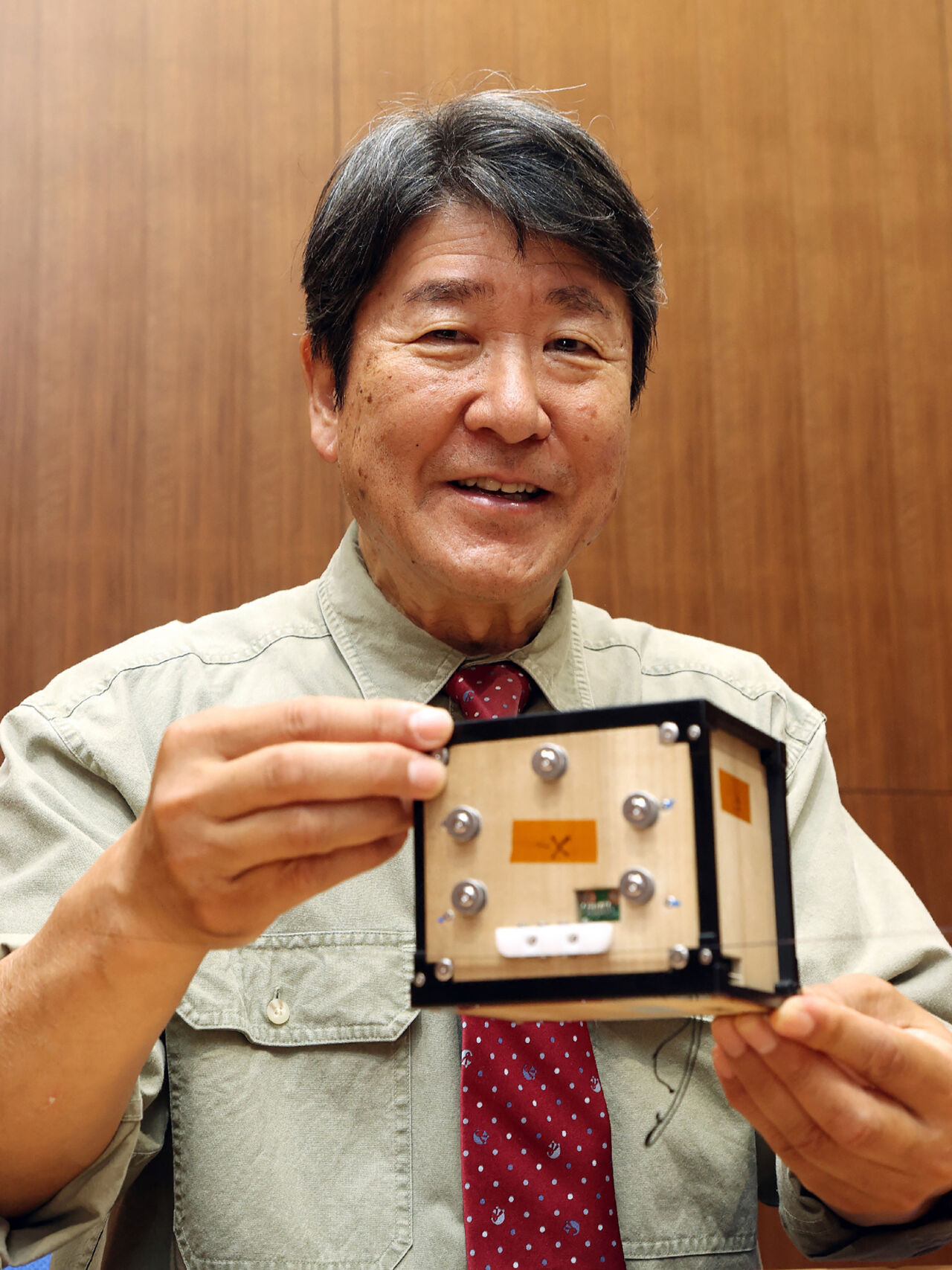 Takao Doi, astronaut and professor at Kyoto University, with the first wooden satellite Takao Doi, astronaut and professor at Kyoto University, with the first wooden satellite