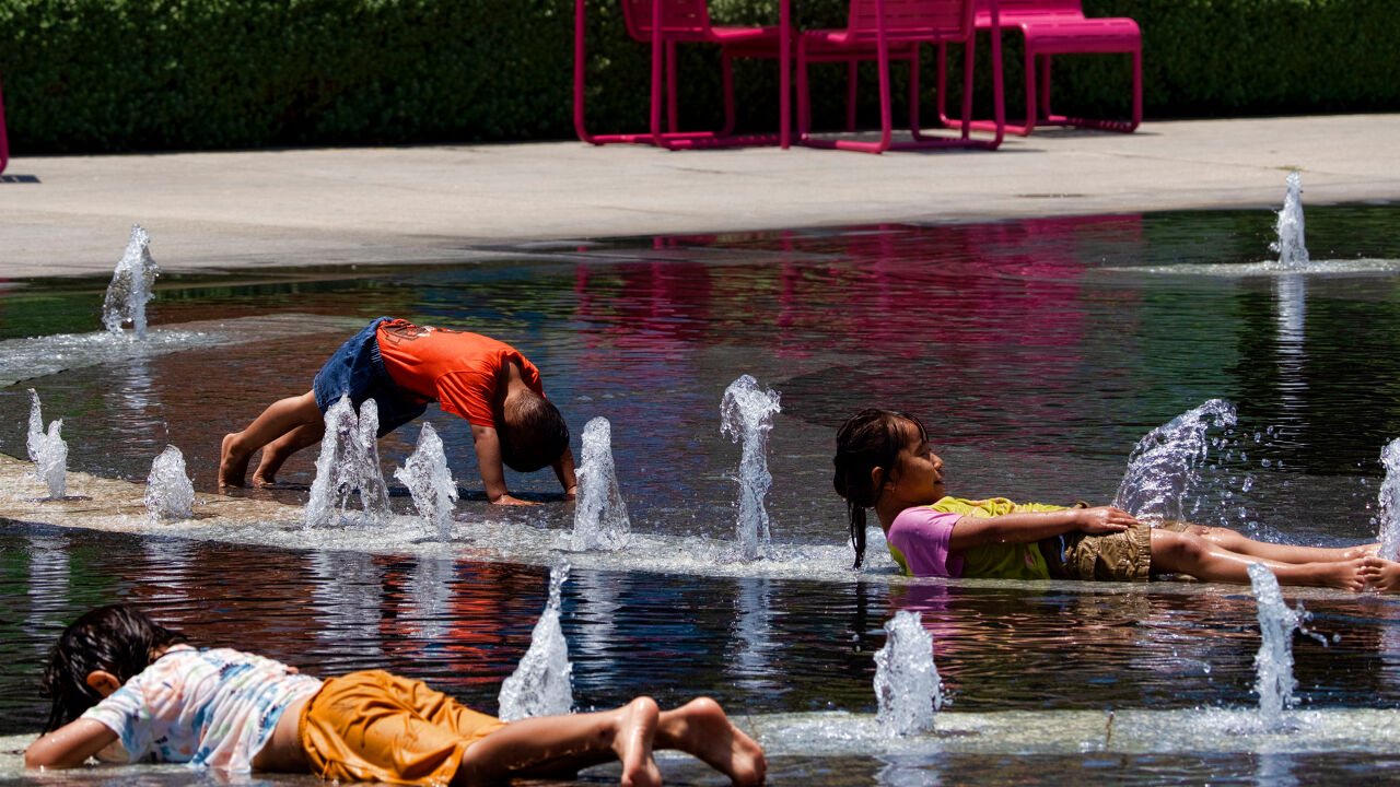 Children resting in a fountain in California Children resting in a fountain in California